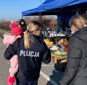 policjantka niosąca dziecko obok idzie kobieta