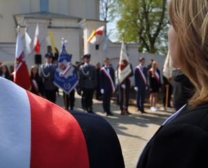 poczet sztandarowy policji na tle flagi białoczerwonej