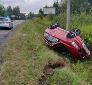 czerwone terenowe volvo leżące do góry kołami w rowie