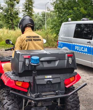 strażak na quadzie w tle radiowóz