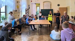 policjantki prezentujące kamizelkę odblaskową uczniom w klasie