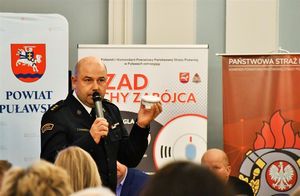 strażak prezentujący czujkę