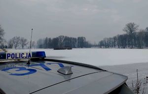 radiowóz obok zamarzniętego stawu