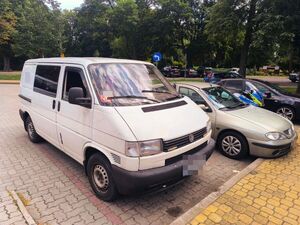 Pojazd Mki Volkswagen na parkingu a w pobliżu motocykl policyjny